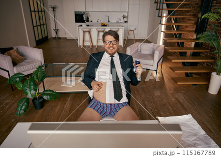 High angle view on funny relaxed businessman having rest during online work High angle view on funny relaxed businessman having rest during online work 115167789