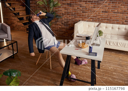 Funny businessman freelancer taking break from online work eating snacks Funny businessman freelancer taking break from online work eating snacks 115167798