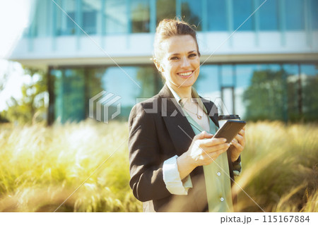 Portrait of happy modern woman worker in business district 115167884