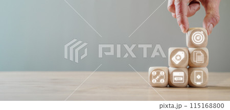 Advertising concept, Hand holding wooden block on desk with Advertising icon on virtual screen. 115168800