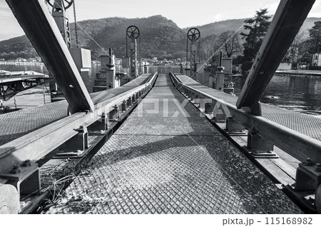 An abandoned metal pier for reloading cargo delivered by water Focus in the middle of the frame Black and white horizontal photo An abandoned metal pier for reloading cargo delivered by water Focus in the middle of the frame Black and white horizontal photo 115168982
