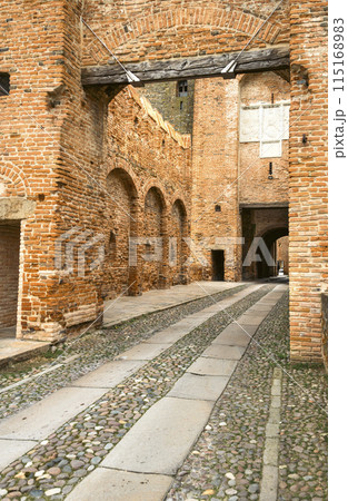 Entrance to the old brick medieval fortress Part of the central entrance in perspective Vertical photo 115168983