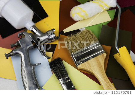 Paint spray gun at work at the workplace in the workshop. Paint Brush 115170791