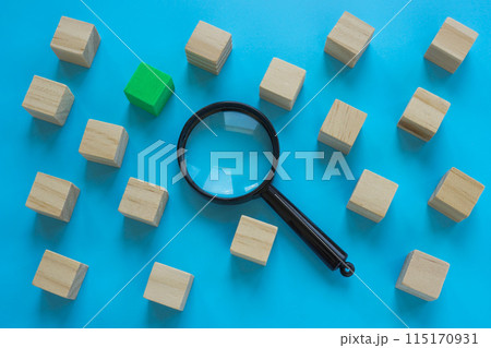 Cubes and a magnifying glass. Talent acquisition or a new employee. 115170931