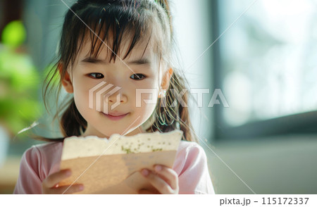 A Generation Alpha girl engages with plantable seed paper, a hands-on learning experience about growth and sustainability. 6 years old kid with sustainability biodegradable greeting card A Generation Alpha girl engages with plantable seed paper, a hands-on learning experience about growth and sustainability. 6 years old kid with sustainability biodegradable greeting card 115172337