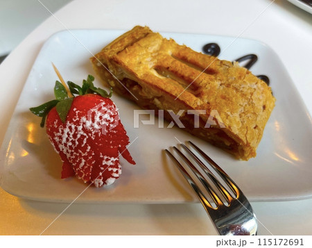 Traditional homemade apple strudel served with coffee.  115172691