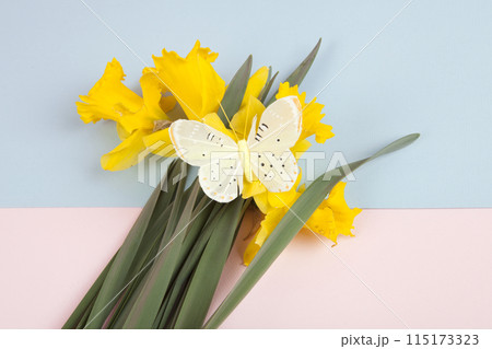 a bouquet of daffodils with a butterfly on it 115173323