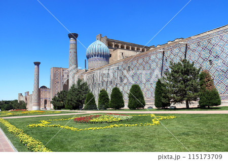 Sher-dor Madrassah, Registan complex, Samarkand, Uzbekistan. Wall, dome and decorative minaret with tile decor, Sher Dor (Lion) Medressa, part of Registan Ensemble 115173709