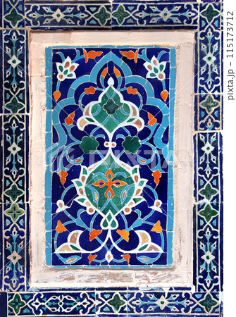 Vertical background with detail of ancient mosaic walls with floral and geometric ornaments. Traditional tile decorations on wall of Sher-dor Madrasah, Registan complex, Samarkand, Uzbekistan 115173712