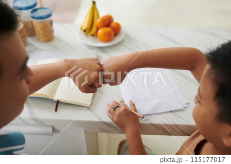 Doing Fist Bump after Finishing Homework Doing Fist Bump after Finishing Homework 115177017