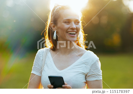 smiling modern 40 years old woman in white shirt 115178397
