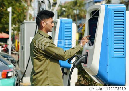 Charging Vehicle at Public Station Charging Vehicle at Public Station 115178610