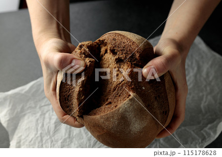 beautiful homemade bread with raisins in female hands beautiful homemade bread with raisins in female hands 115178628
