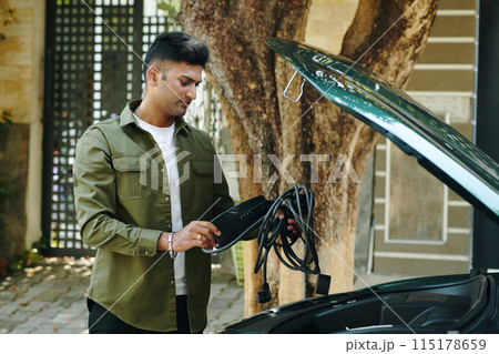 Putting Charging Cable in Trunk 115178659