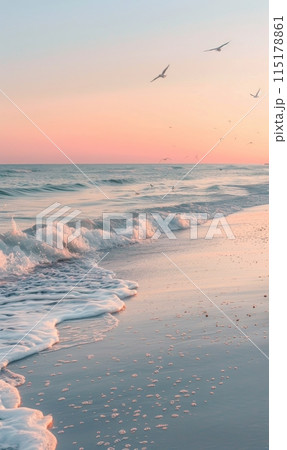 Pink Sunset Over Gentle Ocean Waves on Sandy Beach 115178861