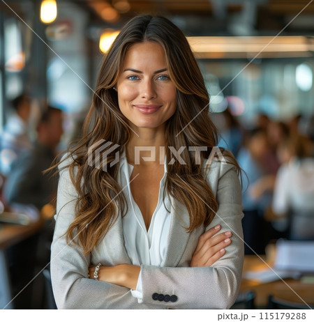 Confident Businesswoman With Arms Crossed in Modern Office Setting 115179288