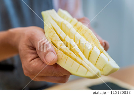 Chef at the kitchen preparing grilled eggplants with garlic 115180838