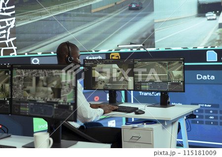 African american call center employee gives updates to customers on order tracking services, ensuring express delivery. Operator sends gps coordinates to couriers, avoiding heavy traffic. 115181009