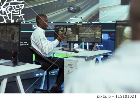 African american call center operator tracking orders for clients, helping couriers find routes in city traffic for express shipping. Monitoring trucks and update clients on potential delay. African american call center operator tracking orders for clients, helping couriers find routes in city traffic for express shipping. Monitoring trucks and update clients on potential delay. 115181021