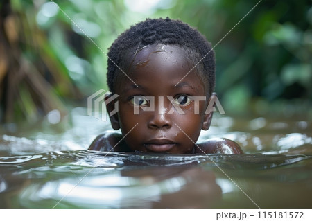 Young Boy Swimming in Natural Water 115181572