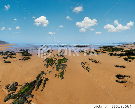Rock formations on sandy beach (Portugal). Rock formations on sandy beach (Portugal). 115182564