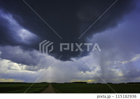 Dramatic storm clouds in blue sky associated with storm, dark, moody weather and looming atmosphere Dramatic storm clouds in blue sky associated with storm, dark, moody weather and looming atmosphere 115182936