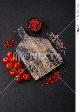 Black background with copy space with cherry tomatoes, salt, spices Black background with copy space with cherry tomatoes, salt, spices 115183265