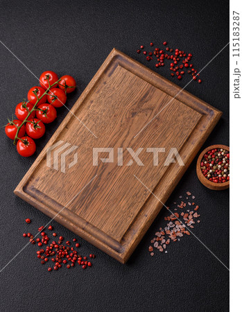 Black background with copy space with cherry tomatoes, salt, spices Black background with copy space with cherry tomatoes, salt, spices 115183287