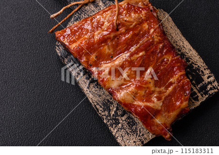 Delicious juicy grilled ribs baked on the grill with salt, spices and herbs 115183311