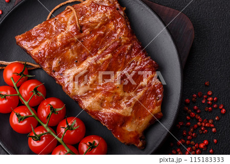 Delicious juicy grilled ribs baked on the grill with salt, spices and herbs Delicious juicy grilled ribs baked on the grill with salt, spices and herbs 115183333