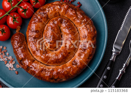 Delicious homemade sausage in the form of a spiral baked on the grill with salt, spices 115183368