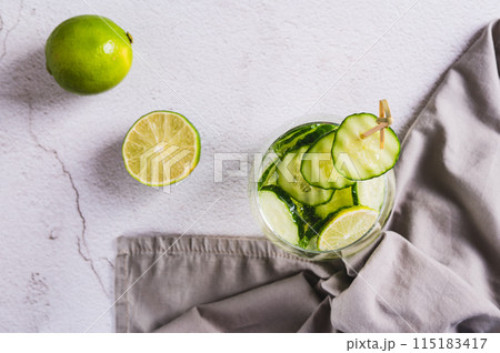 Close up of refreshing carbonated lemonade with lime and cucumber in a glass on the table top view 115183417