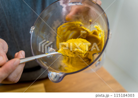 Chef at the kitchen preparing chickpea porridge with ginger 115184303