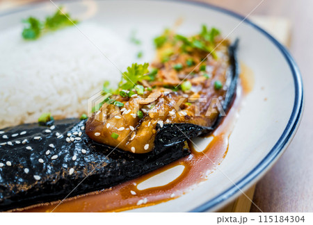 Delicious grilled eggplants with garlic on the white plate 115184304