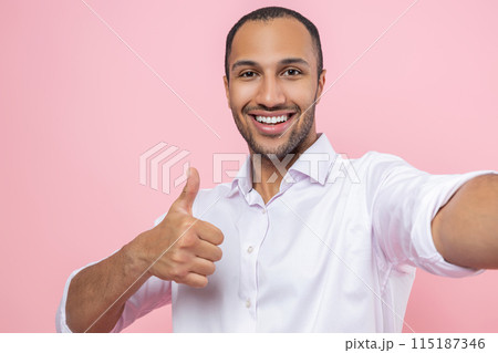 Smiling man in white shirt making point of view photo showing like gesture Smiling man in white shirt making point of view photo showing like gesture 115187346
