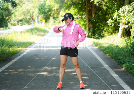 Healthy  woman relax after cool down and looking smart watch for check timing run. 115196633