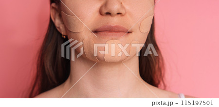 Face tape pasted all over lady's face on pink background Face tape pasted all over lady's face on pink background 115197501