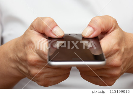 Woman hands holding smartphone concept Arthritis Woman hands holding smartphone concept Arthritis 115199016