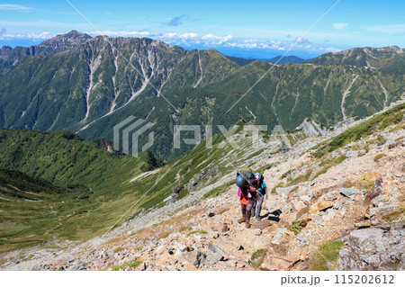 槍ヶ岳への登山道の西鎌尾根を登る女性登山者と笠ヶ岳方面の眺望 115202612