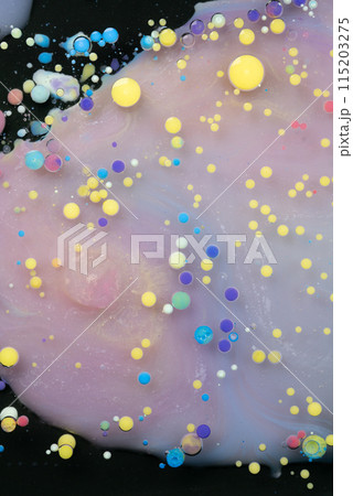 A myriad of oil droplets intermingling with water, creating a mesmerizing effect reminiscent of a galaxy. 115203275