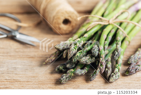 Bunches of green raw  asparagus. 115203334