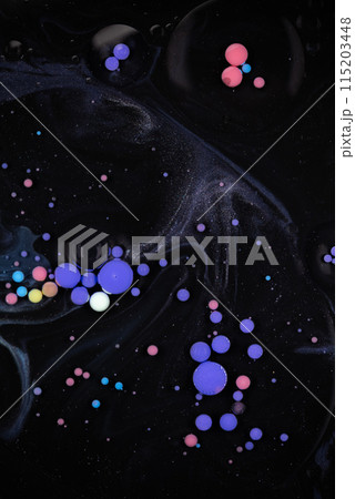 A myriad of oil droplets intermingling with water, creating a mesmerizing effect reminiscent of a galaxy. A myriad of oil droplets intermingling with water, creating a mesmerizing effect reminiscent of a galaxy. 115203448
