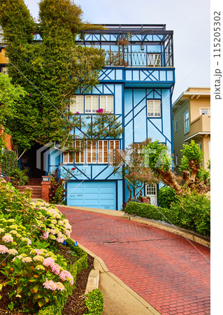 Blue house with gorgeous balcony and red brick road on Lombard Street 115205302