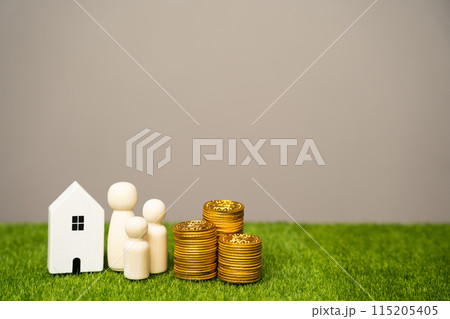 Miniature figures of the family stand near the house and coins. The concept of family budget, mortgage lending and money in the family. Real estate and housing 115205405