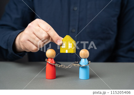 Dividing property after divorce. legal consultation. determine ownership. Divorce proceedings. Conflict upon entering into inheritance. A man holds a house over a people couple. 115205406