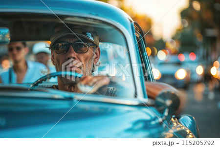Mature man wearing sunglasses and a hat, driving a retro car on a bustling city street 115205792