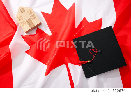 Canadian flag with wooden house and graduate hat Canadian flag with wooden house and graduate hat 115206744