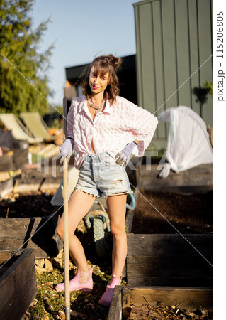 Young woman works on her backyard garden, Young woman works on her backyard garden, 115206805