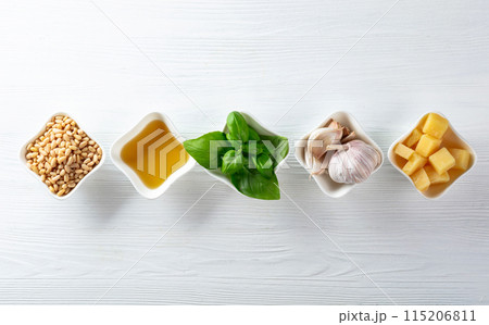 Ingredients for traditional Italian pesto recipe on a wooden background. 115206811
