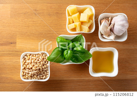 Ingredients for traditional Italian pesto recipe on a wooden background. 115206812
